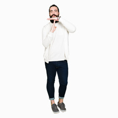 Young hipster man with long hair and beard wearing sporty sweatshirt Doing time out gesture with hands, frustrated and serious face