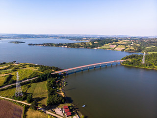 Aerial view of lake, forest and agriculture field by the water, at summer. Gruza lake near the Kragujevac in Serbia.