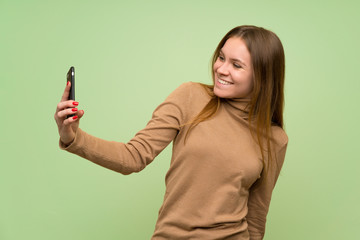 Young woman with turtleneck sweater making a selfie