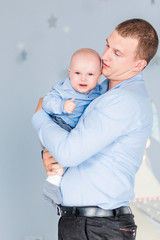 Adorable baby boy  cries and dad calms him down