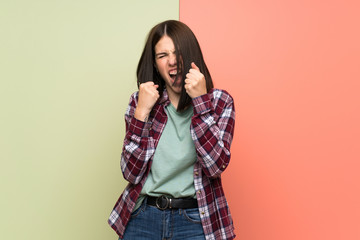 Young woman over isolated colorful wall frustrated by a bad situation