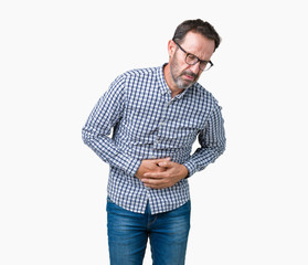 Handsome middle age elegant senior man wearing glasses over isolated background with hand on stomach because nausea, painful disease feeling unwell. Ache concept.