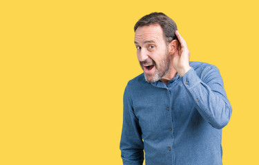 Handsome middle age elegant senior man over isolated background smiling with hand over ear...