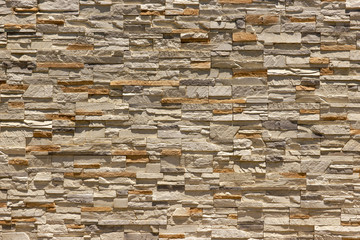 Brick wall of decorative slate stone, colorful horizontal architecture.