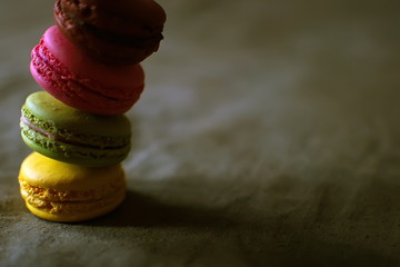 Multi-colored macaroons on a wooden tray. Pink, yellow and green macaroon. - 278224674