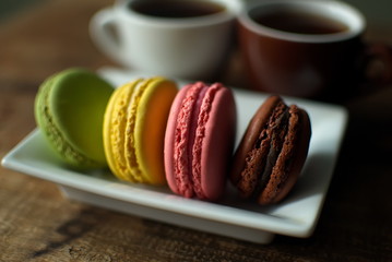 Multi-colored macaroons on a wooden tray. Pink, yellow and green macaroon. - 278224808