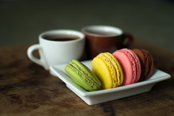 Multi-colored macaroons on a wooden tray. Pink, yellow and green macaroon. - 278224833