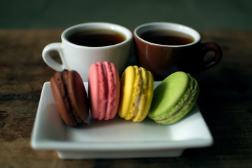 Multi-colored macaroons on a wooden tray. Pink, yellow and green macaroon. - 278224849