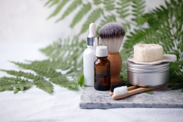 different eco friendly cosmetic products in bathroom. Minimizing ecological footprint concept. Bamboo bath towel, biodegradable bamboo toothbrush, aroma oil