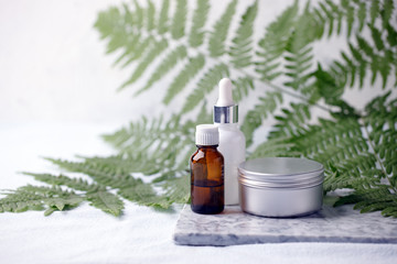 Zero waste bathroom accessories, natural sisal brush, aroma oil, metal jar, essential oil on marble plate, minimal eco-friendly background, minimal stylish set