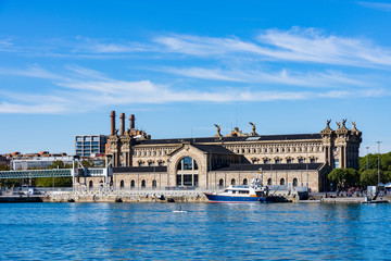 Obraz premium Building of the Barcelona State Agency for Tax Administration in Port Vell, a part of the waterfront harbor in Barcelona
