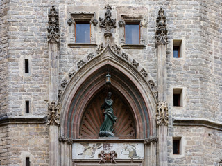 Fototapeta na wymiar Basilica de Santa Maria del Mar, detail of the secondary entrance, with Saint Mary surrounded by a pointed arch. La Ribera, Barcelona.