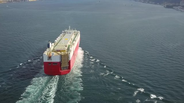 Istanbul Bosphorus Aerial Ro-Ro ship sails out. A PCTC Pure car and truck carrier underway in Turkish Straits. She is heading towards the suspended bridge