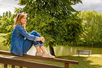 Young pretty woman have a rest in a park. Outdoor relaxing