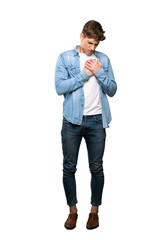 A full-length shot of a Handsome young man having a pain in the heart over isolated white background