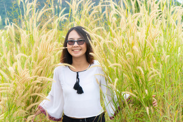 Asian woman relax in grass field.