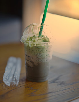 Flappe  or blended coffee on plastic cup and straw in earth care concept