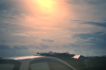 Fototapeta na wymiar Car roof outside in sun set sky clouds background