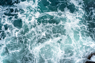 Fototapeta na wymiar landscape of sea waves and foam breaking on rocks