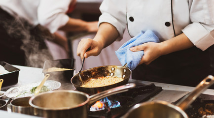 Obraz na płótnie Canvas Chef cooking food in the kitchen, Chef preparing food
