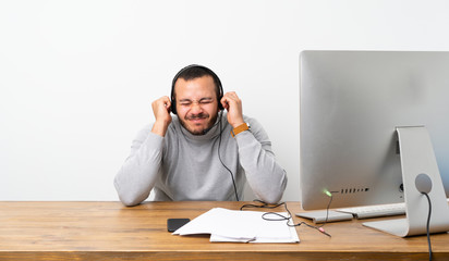 Telemarketer Colombian man frustrated and covering ears