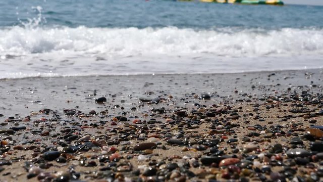 Footage of a waves breaking against a beautiful sand beach in the italian coas close up