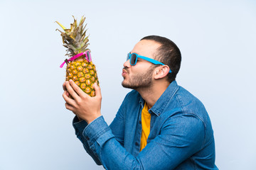 Colombian man holding a pineapple with sunglasses