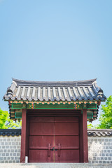 A traditional Korean gate under clear blue skies providing copy space.