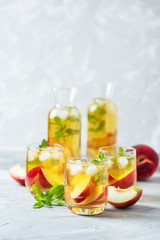 Fototapeta na wymiar Summer cold tea with peaches and mint
