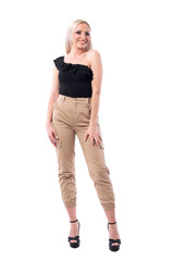 Happy sexy young blond hair woman in creme pants and off shoulder top posing.  Full body isolated on white background.