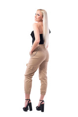 Fototapeta premium Side view of beautiful blonde stylish young woman in off shoulder top smiling looking up. Full body isolated on white background.