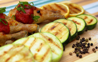 grilled chicken, zucchini and lemon, bright background, side view