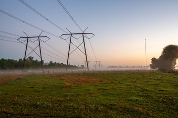 Fototapeta na wymiar Power line on misty field