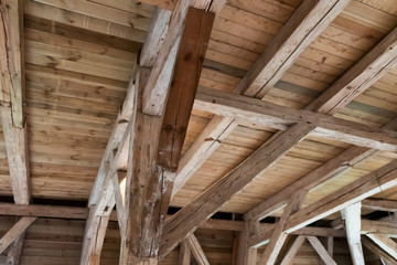 Fototapeta na wymiar Wooden beams in the attic, wooden roof of an old building