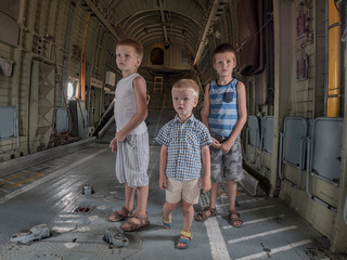 Happy kids in cargo hold of heavy army helicopter