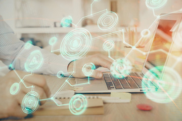 Social network theme hologram with businessman working on computer on background. Concept of world...