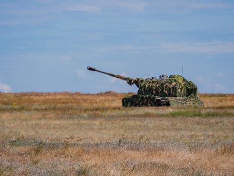 heavy tanks shoot guns and machine guns at combat positions