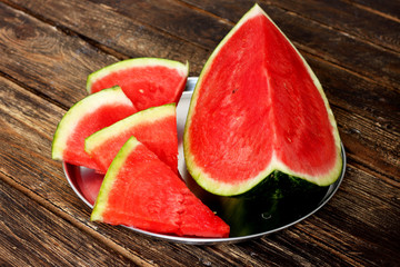 slices of watermelon on wooden table