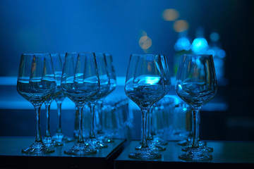 Empty wine glasses on color background