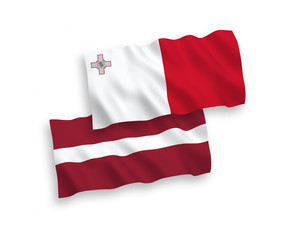 National vector fabric wave flags of Latvia and Malta isolated on white background. 1 to 2 proportion.