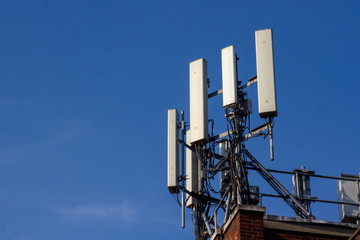 Wifi tower or antenna seen outside in front of a clear blue sky