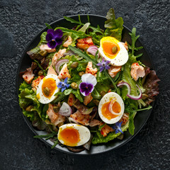 Smoked salmon and jammy soft-boiled free range egg and capers salad with edible borage and pansy flowers