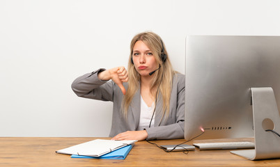 Young woman working with headset showing thumb down sign