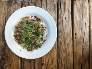 Nutty Fusilli (Italian pasta) with chicken, vegetables, Arugula and pesto sauce.  Gluten free dish. Flat lay.  Top view.