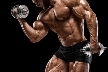 Fototapeta na wymiar Muscular man doing exercises for biceps isolated on the black background. Bodybuilder male naked torso abs