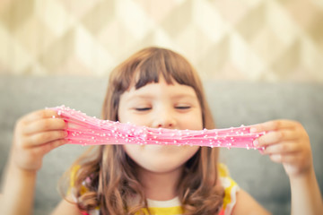 Little girl holding pink slime