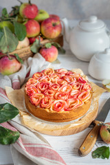 Cake with apple roses and custard cream. Apple pie decorated with apple slices