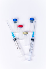 Veterinary and medical glass vials and two syringes for vaccination on a white isolated background. Liquid drug or vaccine to treat people and Pets against viruses, diseases, flu, rabies. Copy spase
