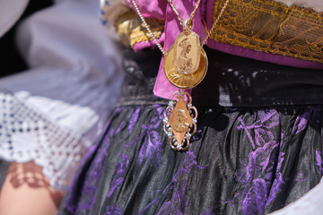 A woman dressed in typical Sardinian costume with different Sardinian ornamental golden jewels.