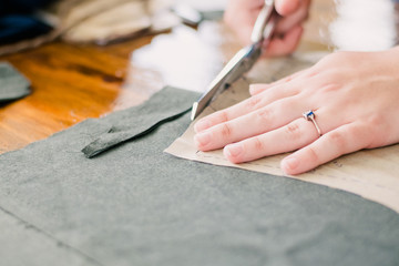 Obraz premium Person Cutting Fabric from a Pattern